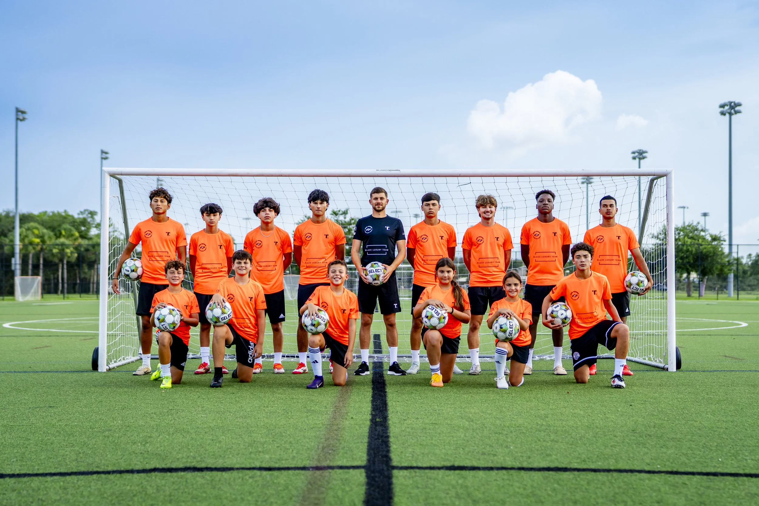 Coach David Popovski with his players in front of the goal